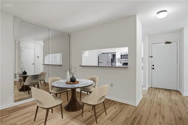 a dining room with furniture and wooden floor