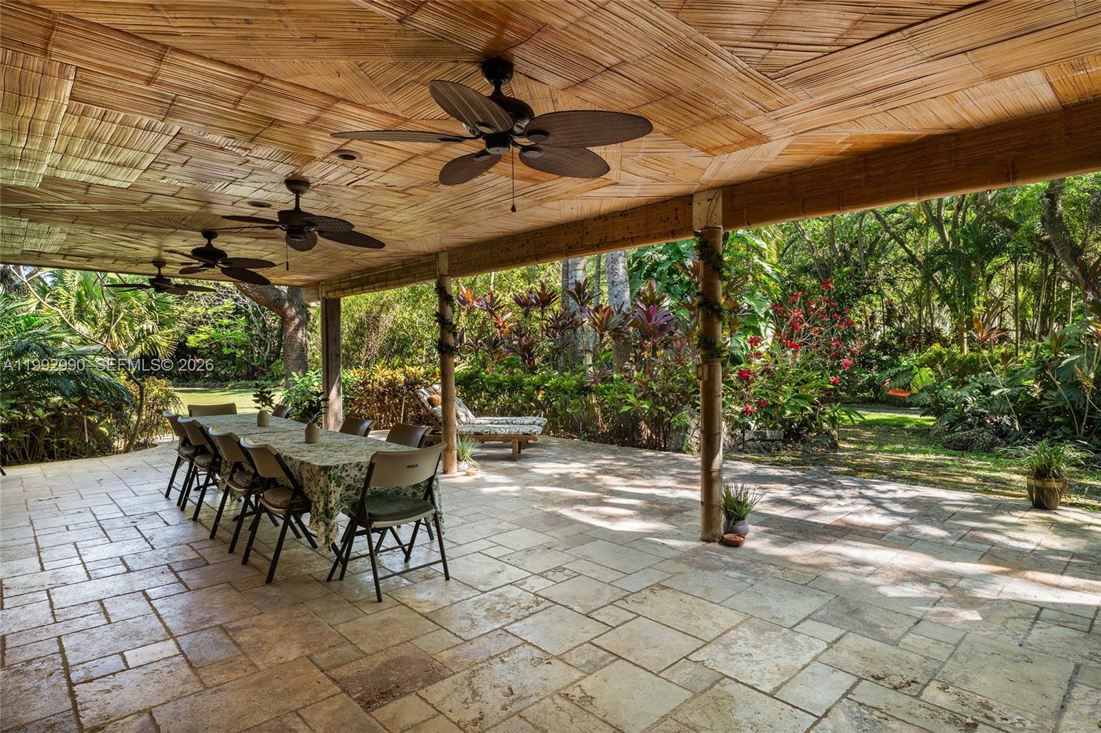 15000 Southwest 200th Street Miami, FL 33187 - Photo 21 of 76 a view of a patio with a table and chairs under an umbrella with a small yard