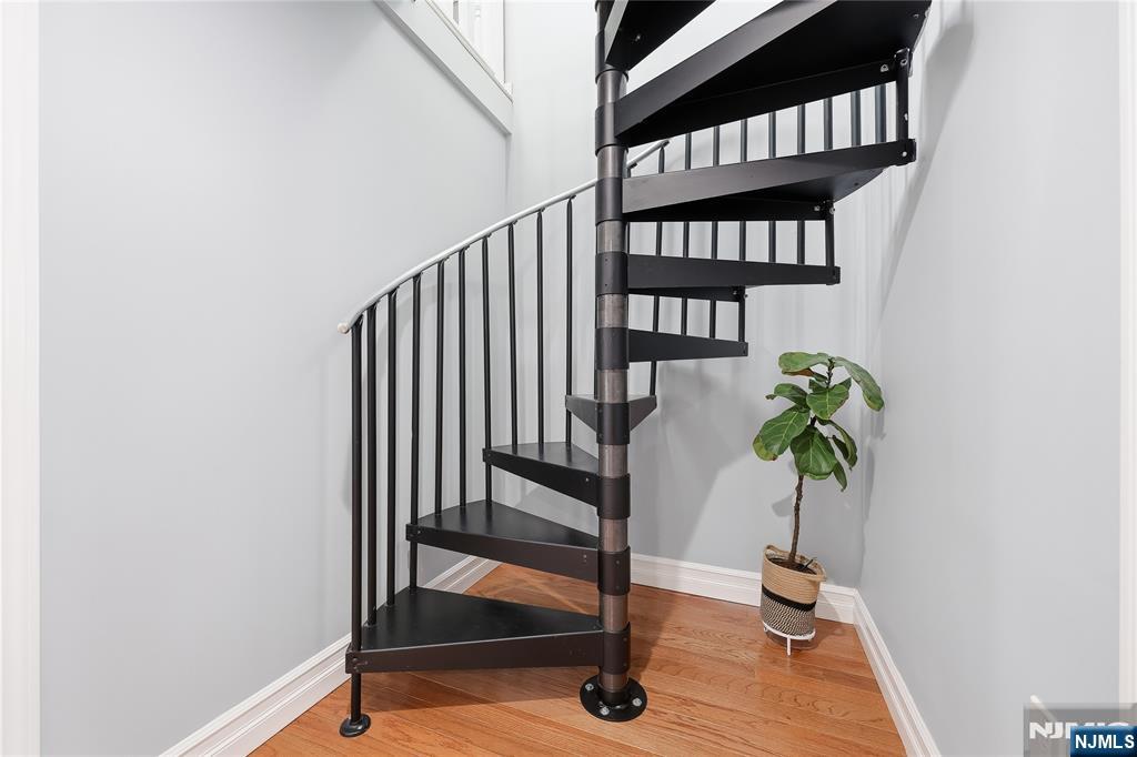 42 South Demarest Avenue Bergenfield, NJ 07621 - Photo 21 of 39 a view of staircase with wooden floor and a potted plant