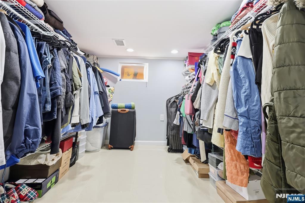 42 South Demarest Avenue Bergenfield, NJ 07621 - Photo 30 of 39 a view of walk in closet with clothes