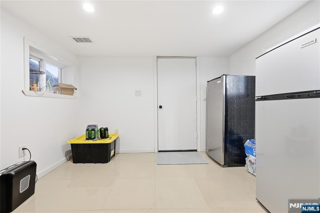 42 South Demarest Avenue Bergenfield, NJ 07621 - Photo 31 of 39 a kitchen with refrigerator and cabinet