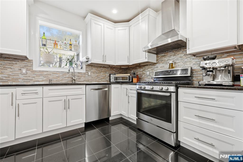 42 South Demarest Avenue Bergenfield, NJ 07621 - Photo 9 of 39 a kitchen with white cabinets and appliances