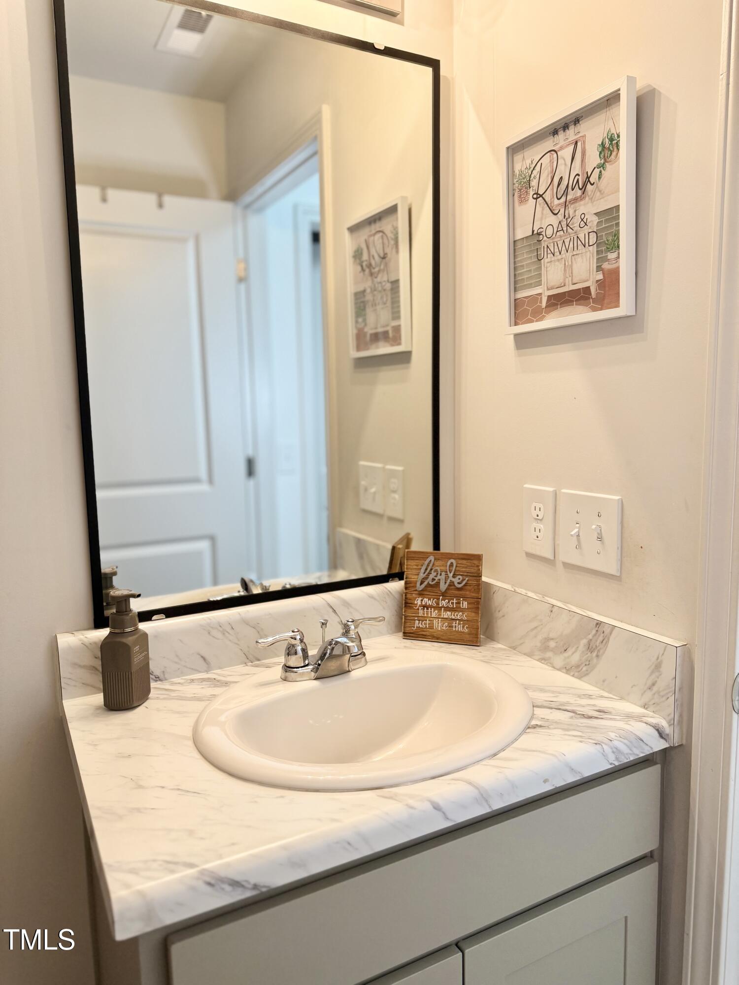 150 Riley Way Spring Hope, NC 27882 - Photo 12 of 27 a bathroom with a granite countertop sink and a mirror