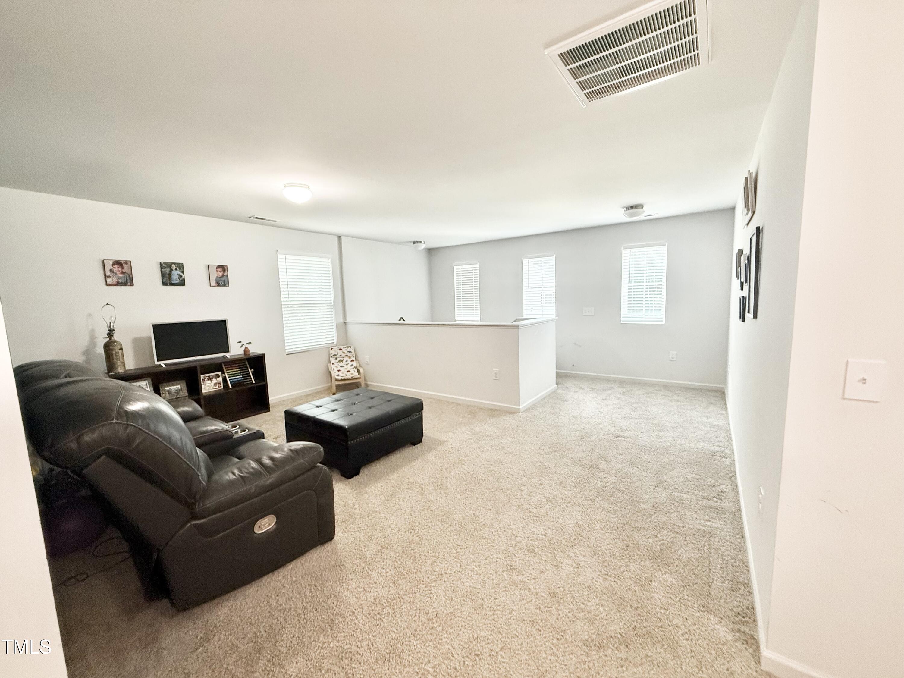 150 Riley Way Spring Hope, NC 27882 - Photo 13 of 27 a living room with furniture and a flat screen tv