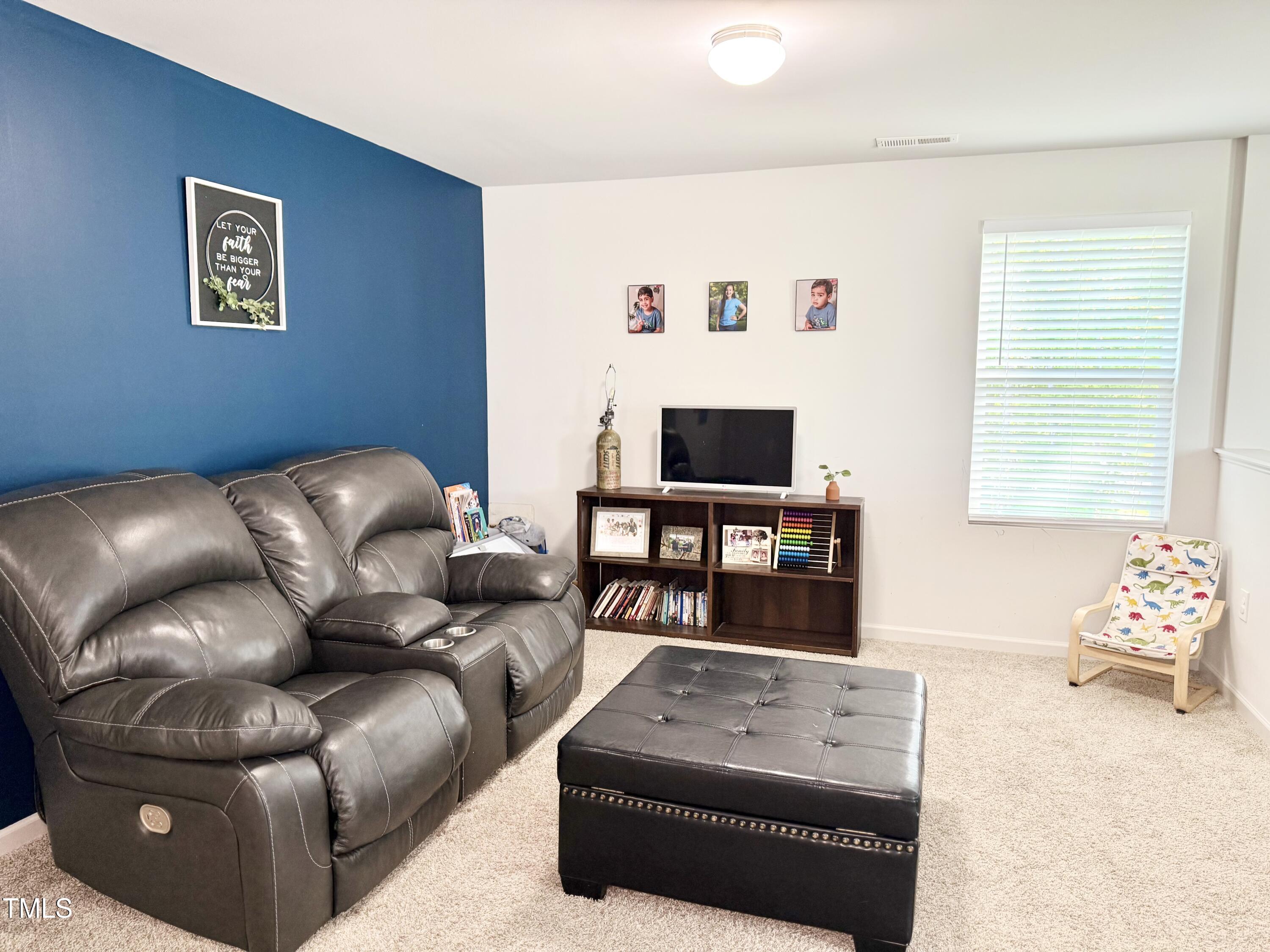 150 Riley Way Spring Hope, NC 27882 - Photo 15 of 27 a living room with furniture and a flat screen tv