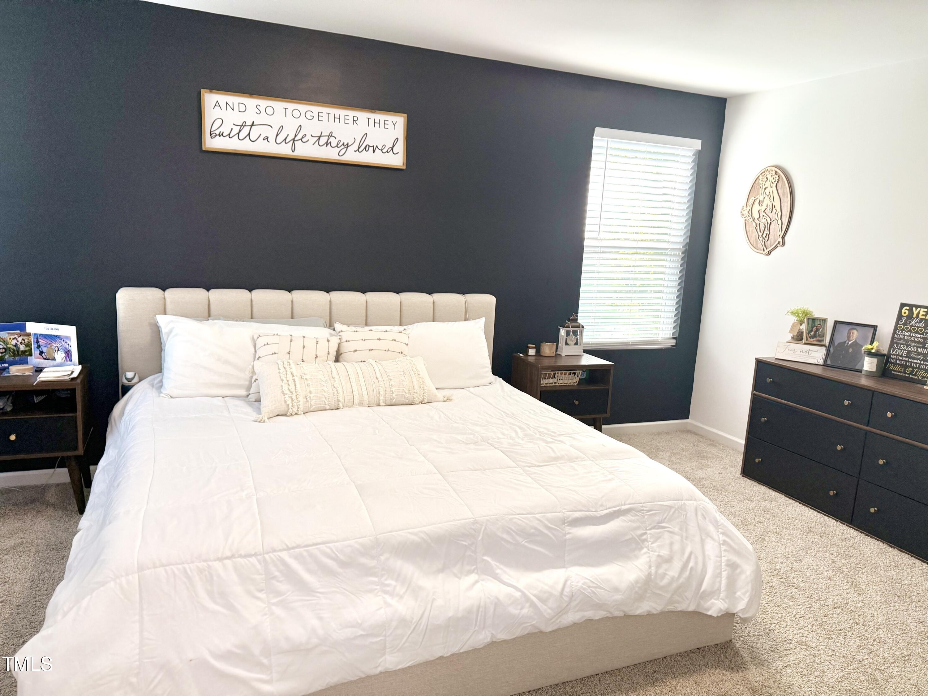 150 Riley Way Spring Hope, NC 27882 - Photo 17 of 27 a bedroom with a bed and a potted plant