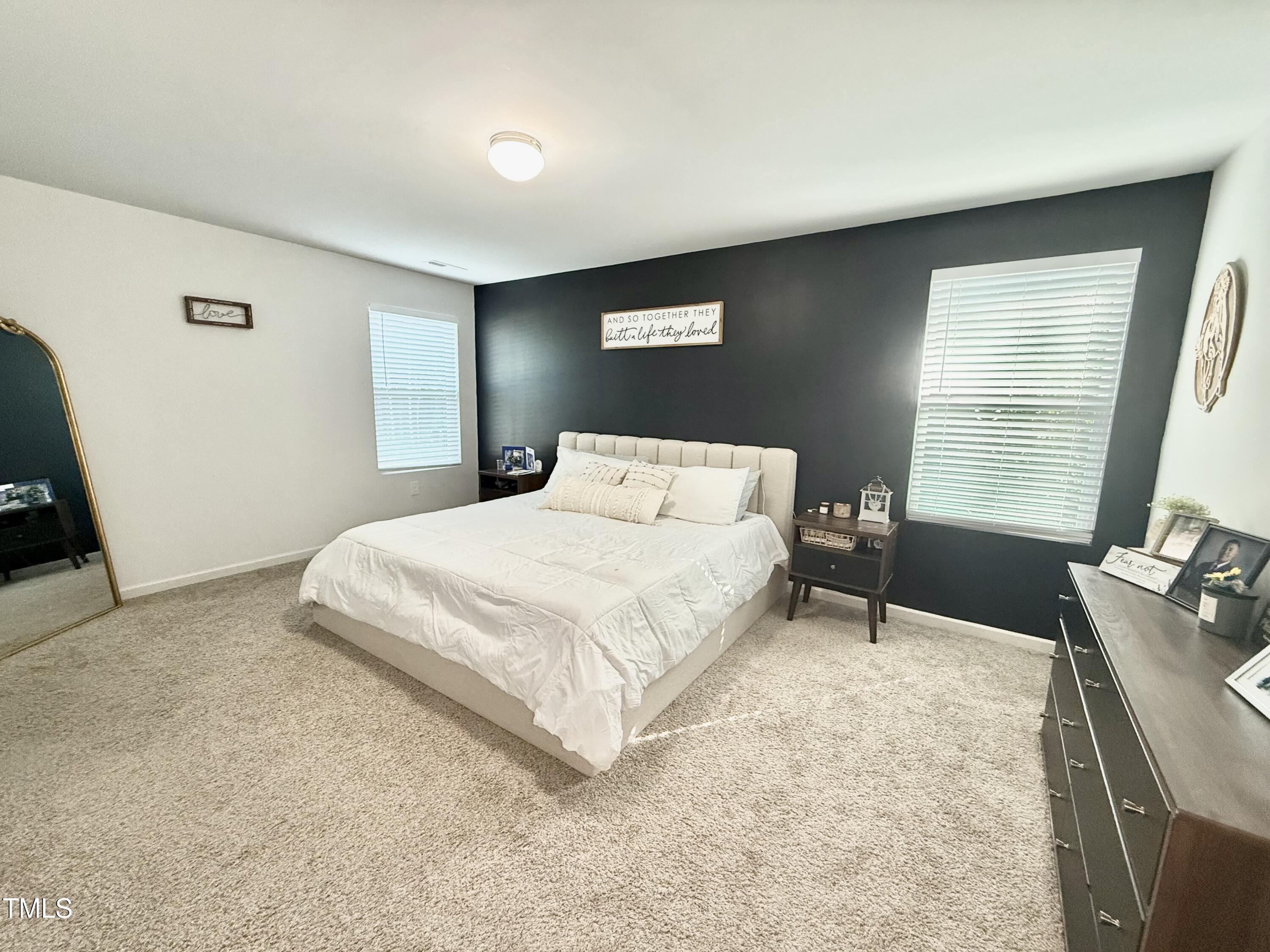 150 Riley Way Spring Hope, NC 27882 - Photo 18 of 27 a bedroom with a bed and window
