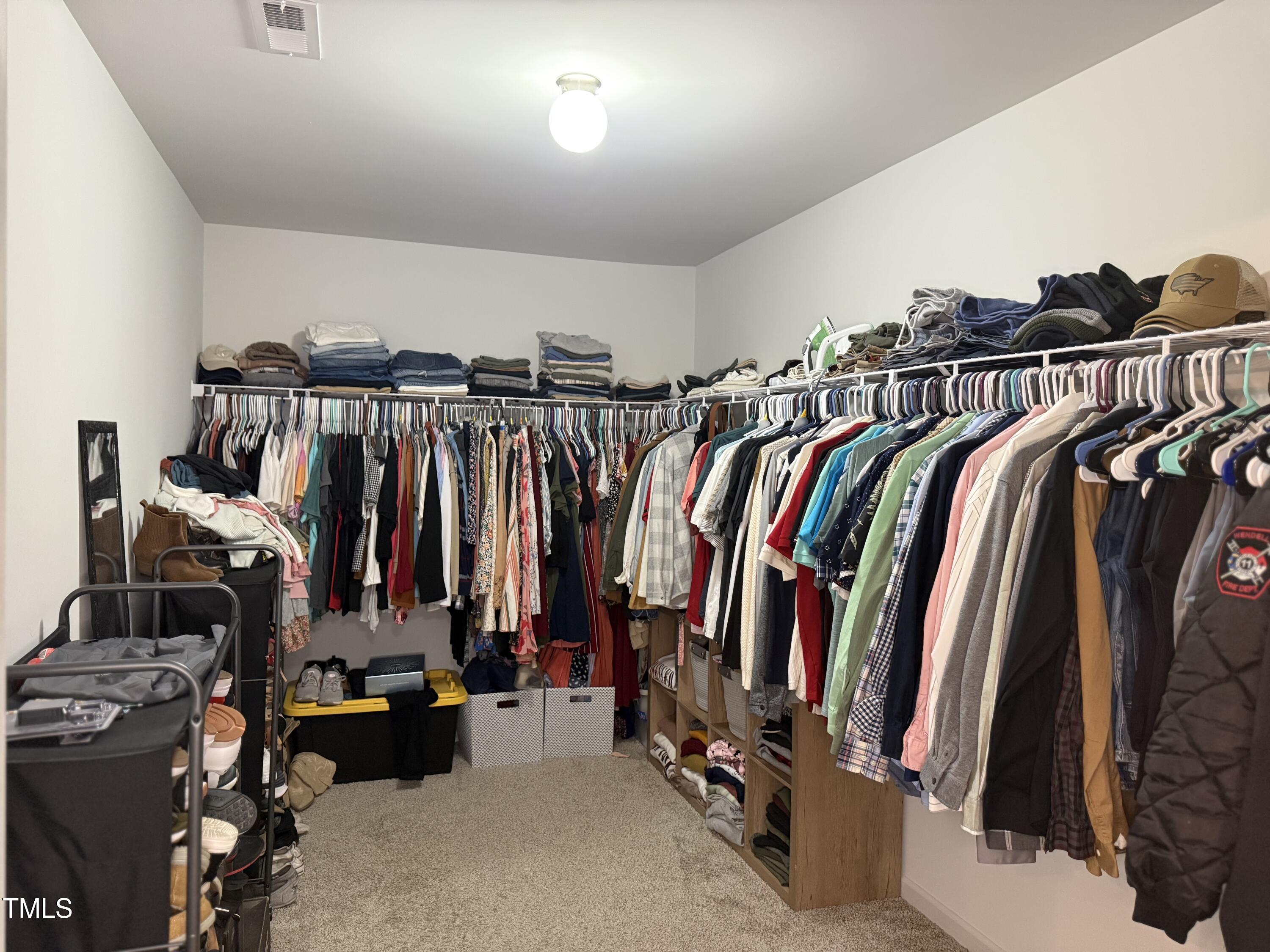 150 Riley Way Spring Hope, NC 27882 - Photo 22 of 27 a view of walk in closet with clothes