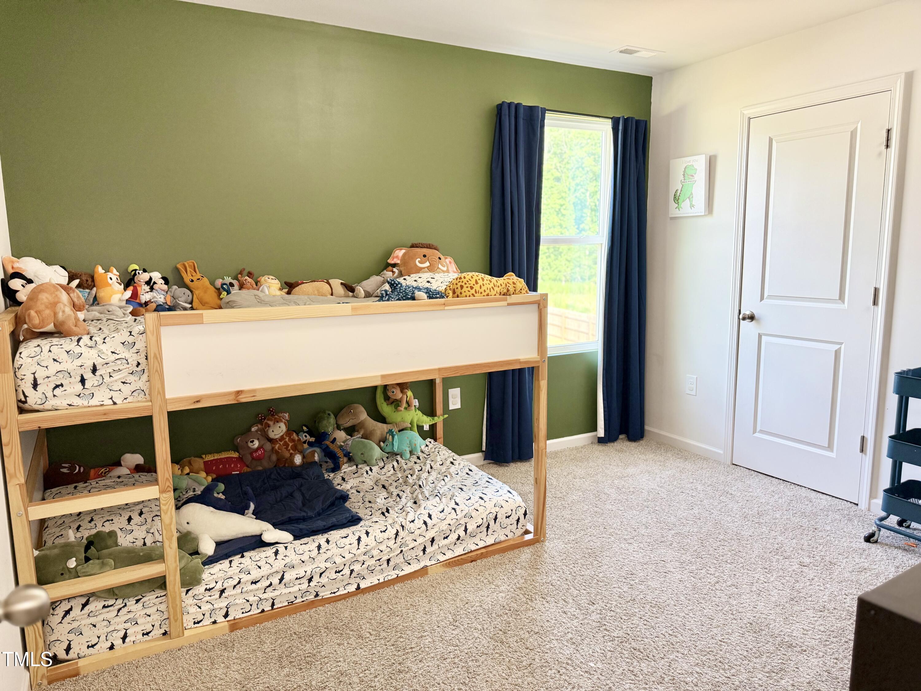 150 Riley Way Spring Hope, NC 27882 - Photo 24 of 27 a bed sitting in a bedroom and next to a window