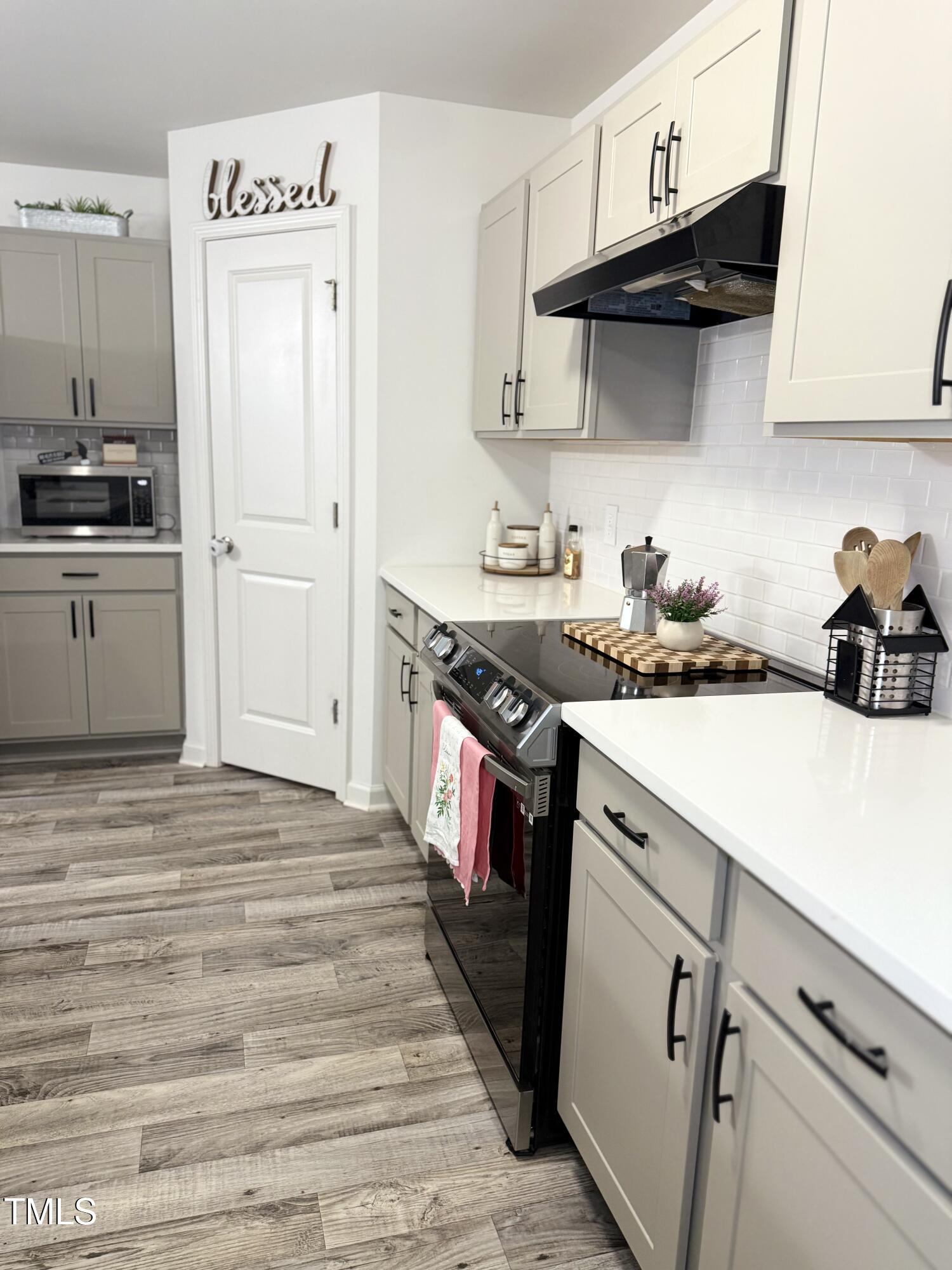150 Riley Way Spring Hope, NC 27882 - Photo 4 of 27 a kitchen with stainless steel appliances a stove a sink and a refrigerator