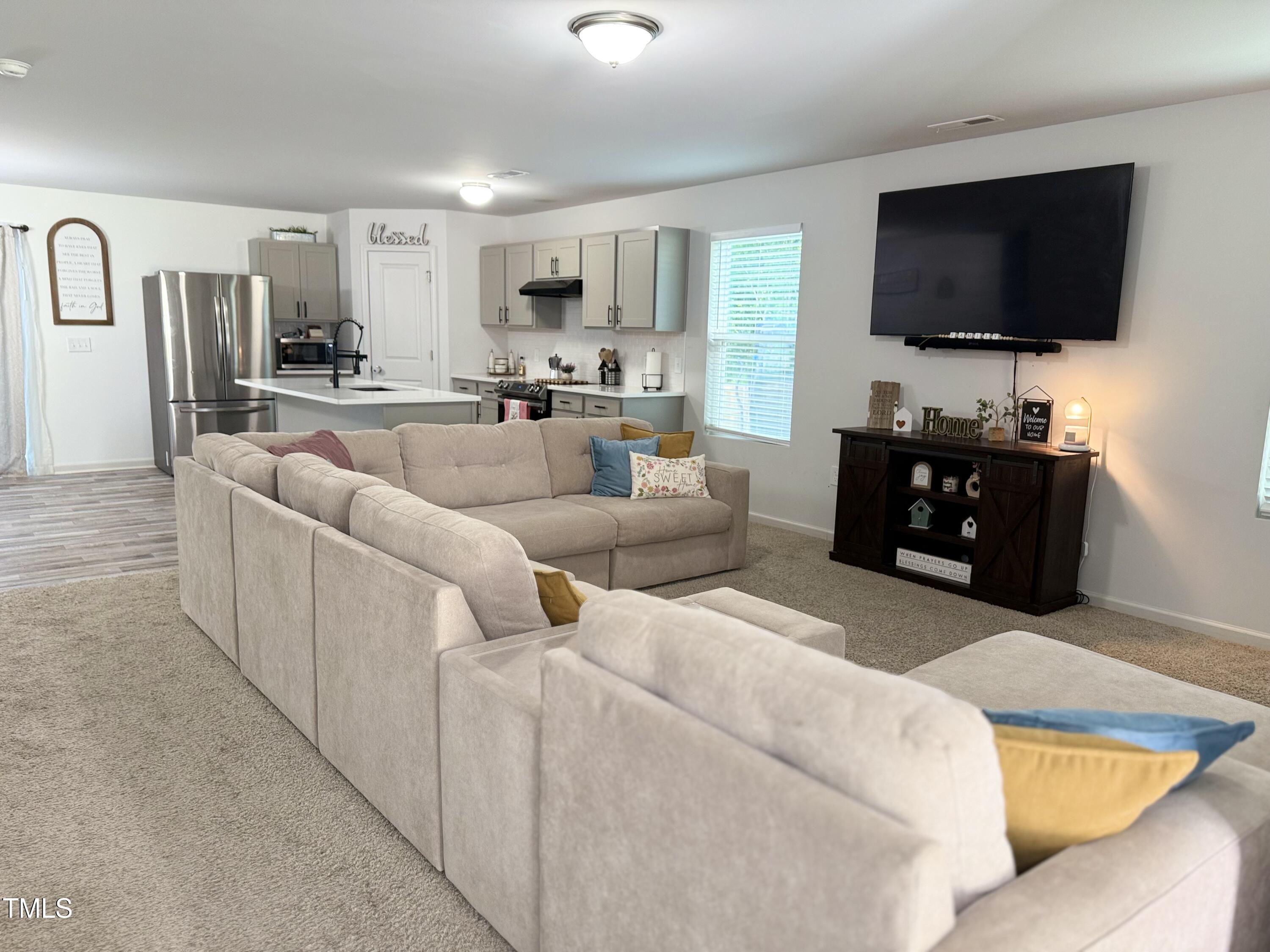 150 Riley Way Spring Hope, NC 27882 - Photo 5 of 27 a living room with furniture and a flat screen tv