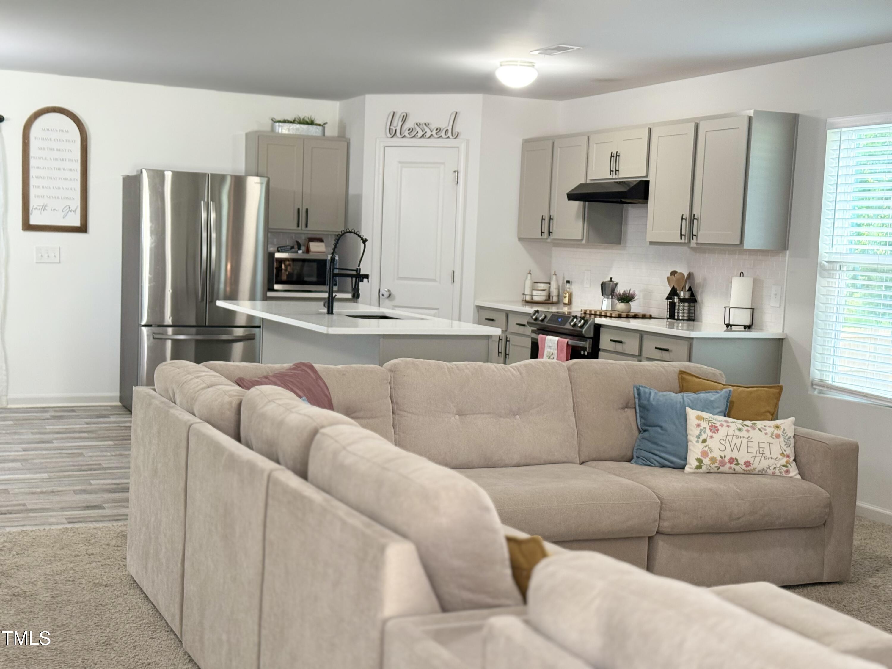 150 Riley Way Spring Hope, NC 27882 - Photo 6 of 27 a living room with furniture a refrigerator and a view of kitchen