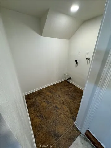 an empty room with a window and a ceiling fan