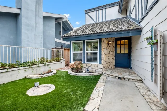 a front view of a house with a yard fire pit and outdoor seating
