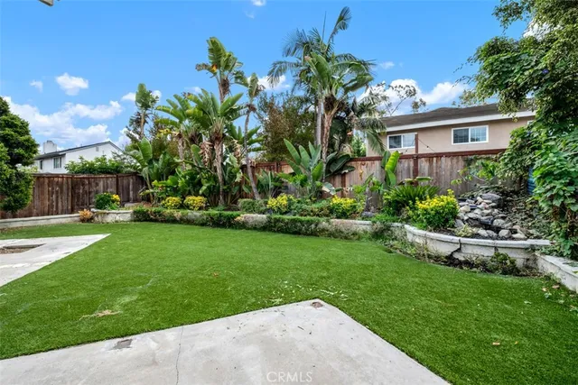 a front view of a house with a garden and patio