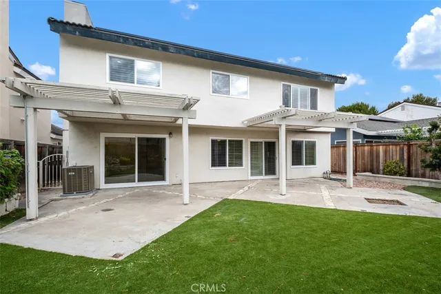 an aerial view of a house with a yard and potted plants