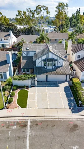 an aerial view of residential houses with city view