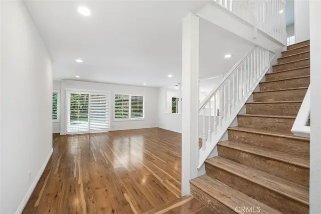 a view of an entryway with wooden floor and stairs