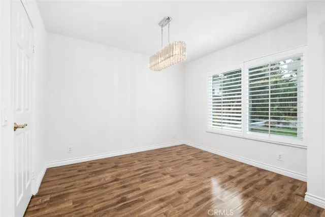a view of a room with a window and wooden floor
