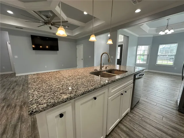 a bathroom with a sink a large mirror and vanity
