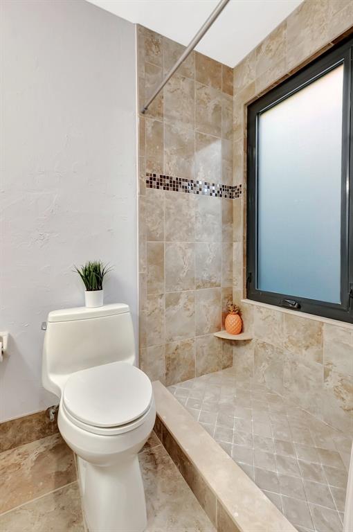 3180 Northwest 13th Street Delray Beach, FL 33445 - Photo 21 of 52 a white toilet sitting next to a bathroom sink