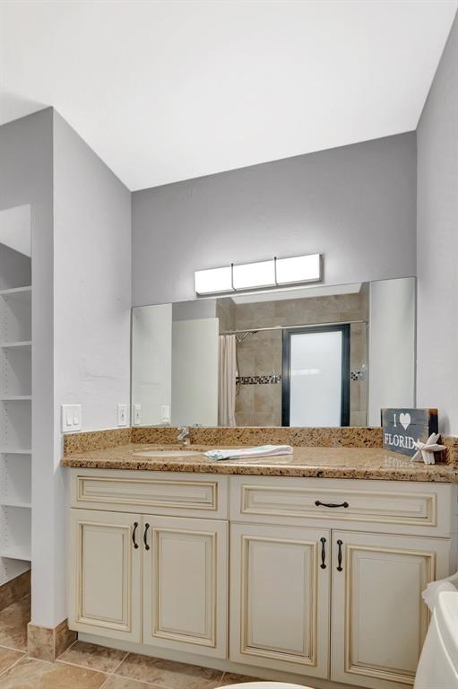 3180 Northwest 13th Street Delray Beach, FL 33445 - Photo 22 of 52 a bathroom with a granite countertop sink and a mirror