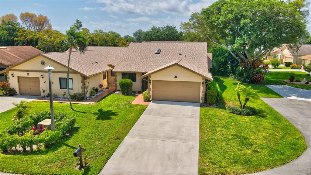 3180 Northwest 13th Street Delray Beach, FL 33445 - Photo 28 of 52 a aerial view of a house with a big yard potted plants and large tree