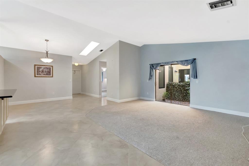 3180 Northwest 13th Street Delray Beach, FL 33445 - Photo 3 of 52 an empty room with entrance and windows