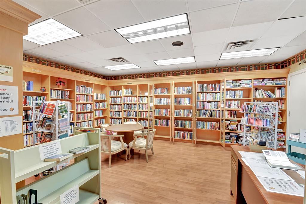 3180 Northwest 13th Street Delray Beach, FL 33445 - Photo 37 of 52 a reading room with furniture and book shelf