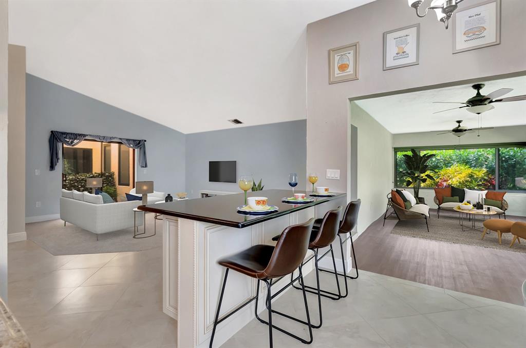 3180 Northwest 13th Street Delray Beach, FL 33445 - Photo 7 of 52 a view of a dining room with furniture and a potted plant