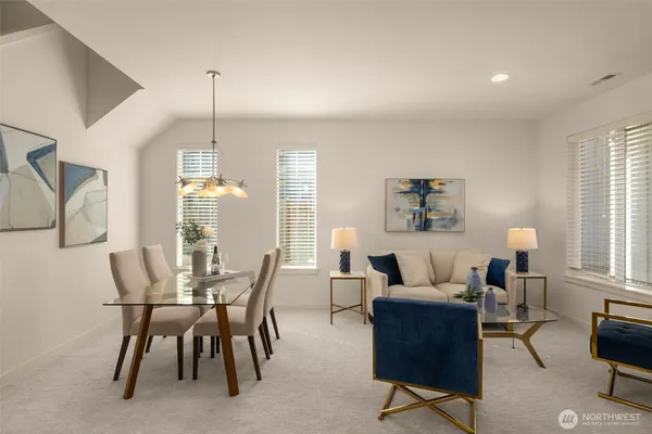 a living room with furniture a large window and a fireplace