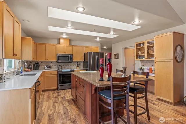 a kitchen with a table chairs refrigerator and cabinets