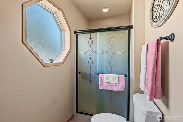 a bathroom with a shower and a mirror