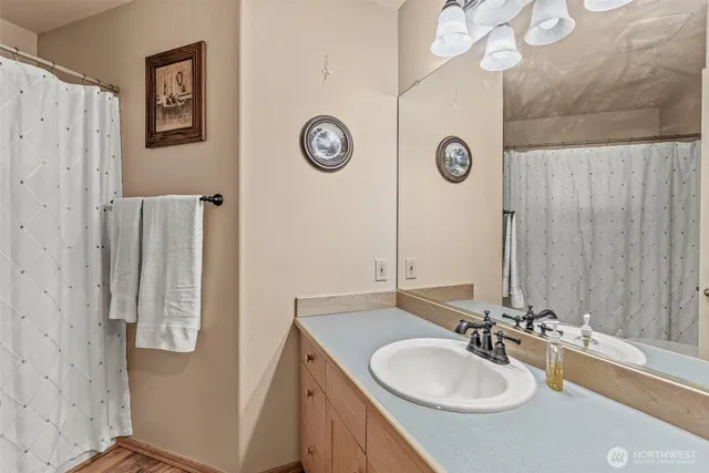 a bathroom with a sink vanity and a mirror