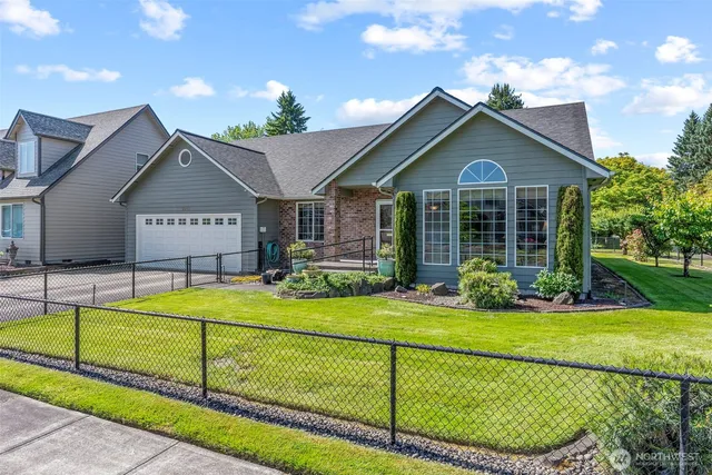 a view of a house with a big yard and potted plants