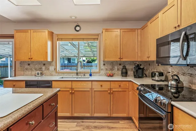 a kitchen with a sink stove top oven and cabinets