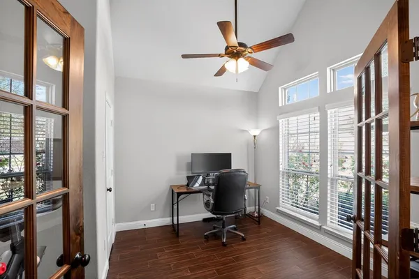a view of a workspace with furniture and a window