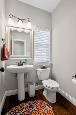 a bathroom with a sink toilet and mirror