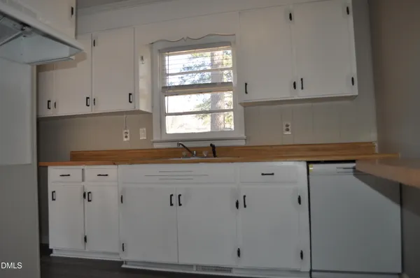 a kitchen with cabinets appliances and a window
