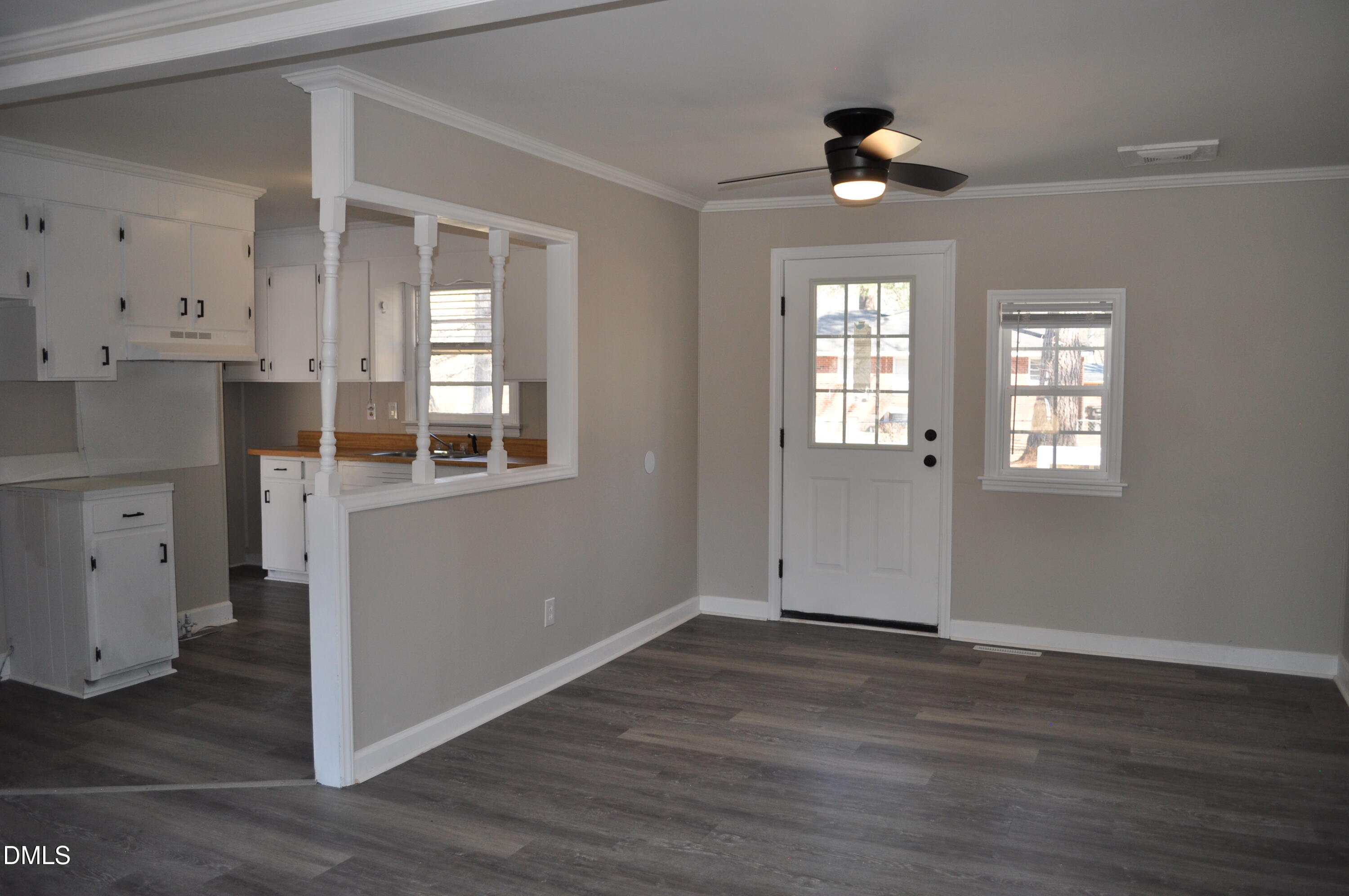 403 Huntington Road Tarboro, NC 27886 - Photo 22 of 42 an empty room with wooden floor cabinet and windows