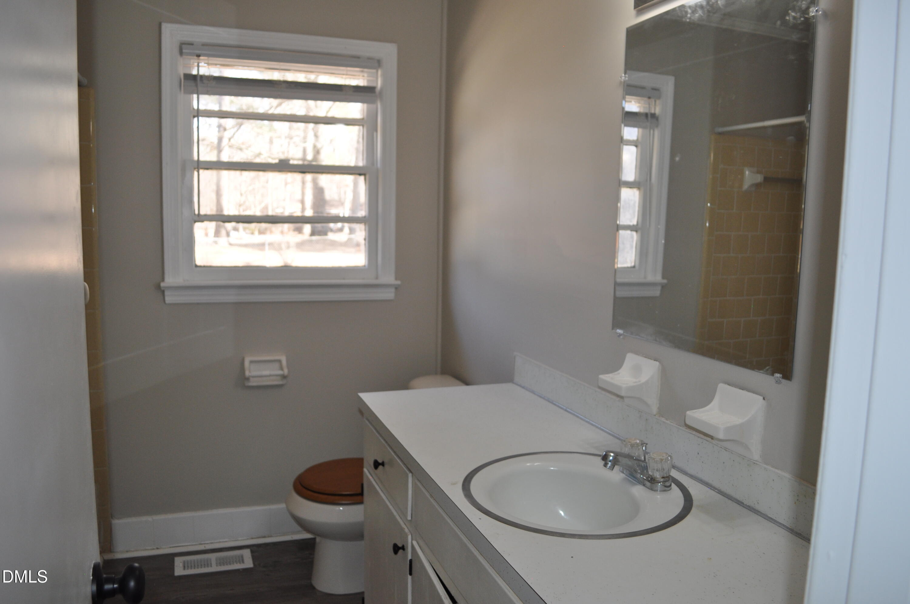 403 Huntington Road Tarboro, NC 27886 - Photo 30 of 42 a bathroom with a toilet sink and mirror