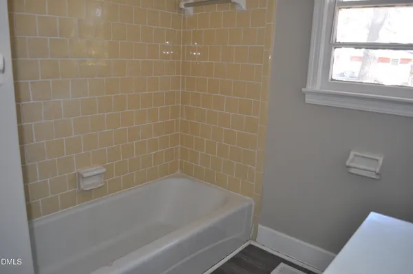 a bath tub sitting next to a window