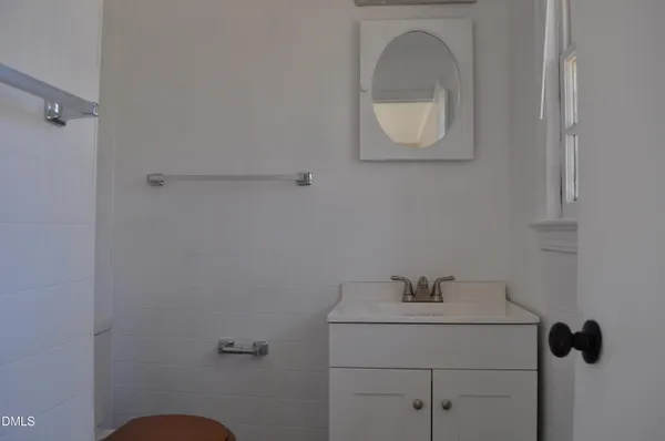 a bathroom with a sink toilet and mirror
