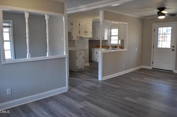 wooden floor in an empty room with a window