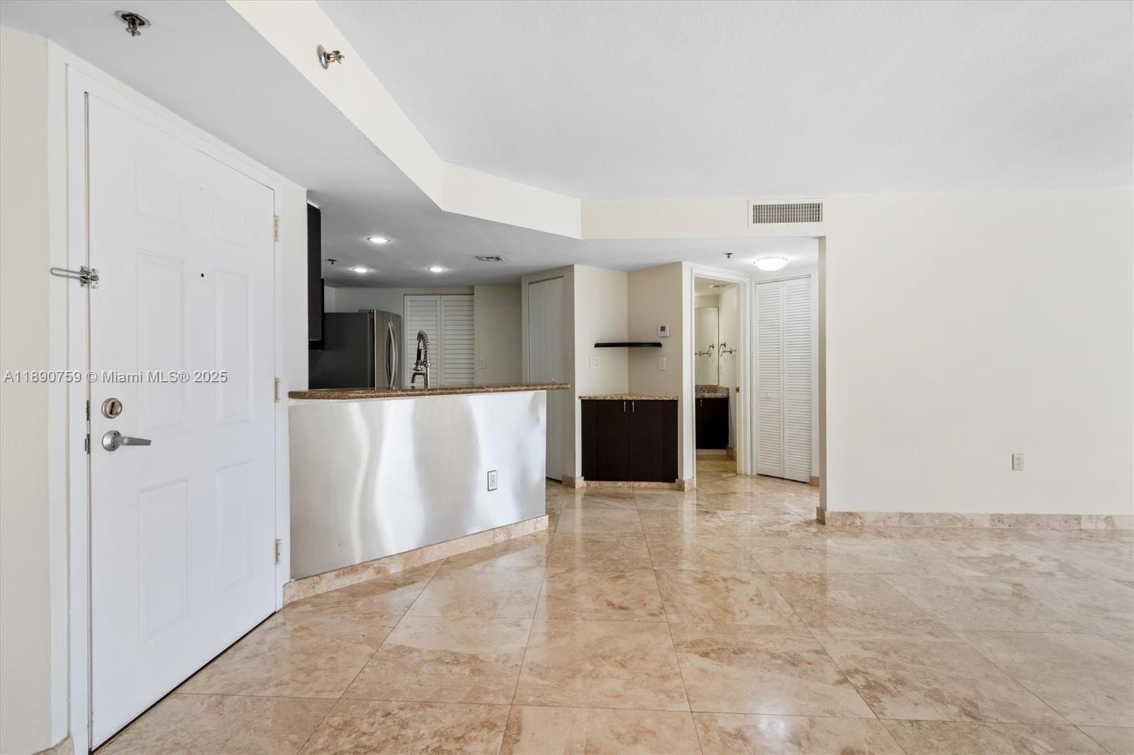 2351 Douglas Road, Unit 906 Miami, FL 33145 - Photo 13 of 45 a view of kitchen with refrigerator and white cabinets
