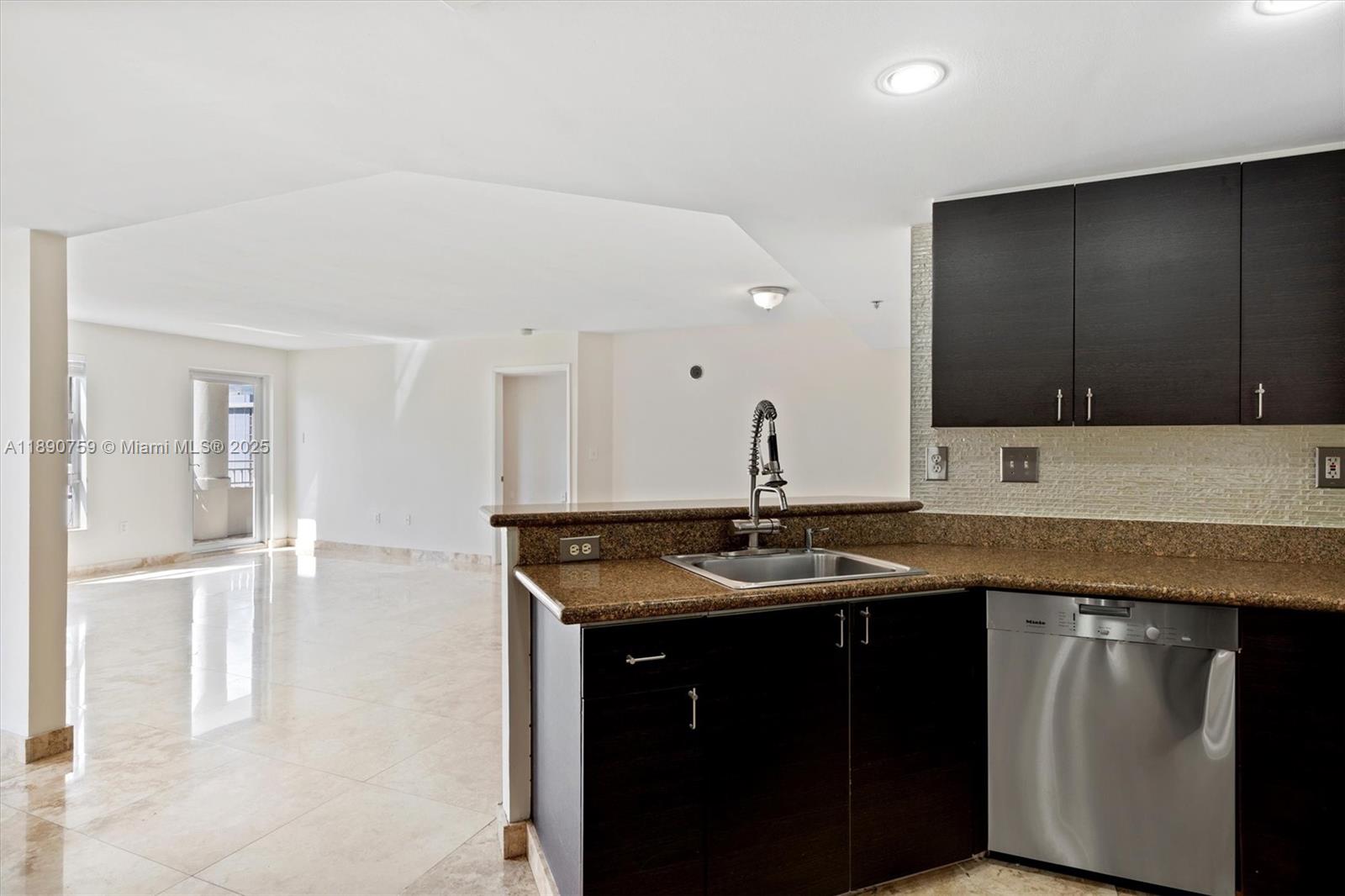 2351 Douglas Road, Unit 906 Miami, FL 33145 - Photo 15 of 45 a kitchen with a sink and cabinets