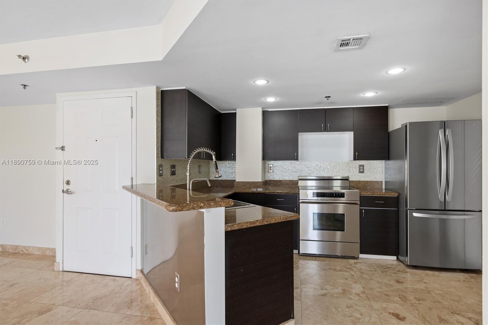 2351 Douglas Road, Unit 906 Miami, FL 33145 - Photo 16 of 45 a kitchen with granite countertop a refrigerator stove and sink