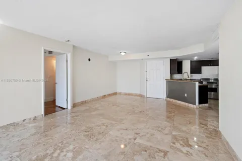 a view of a kitchen with a sink and stainless steel appliances