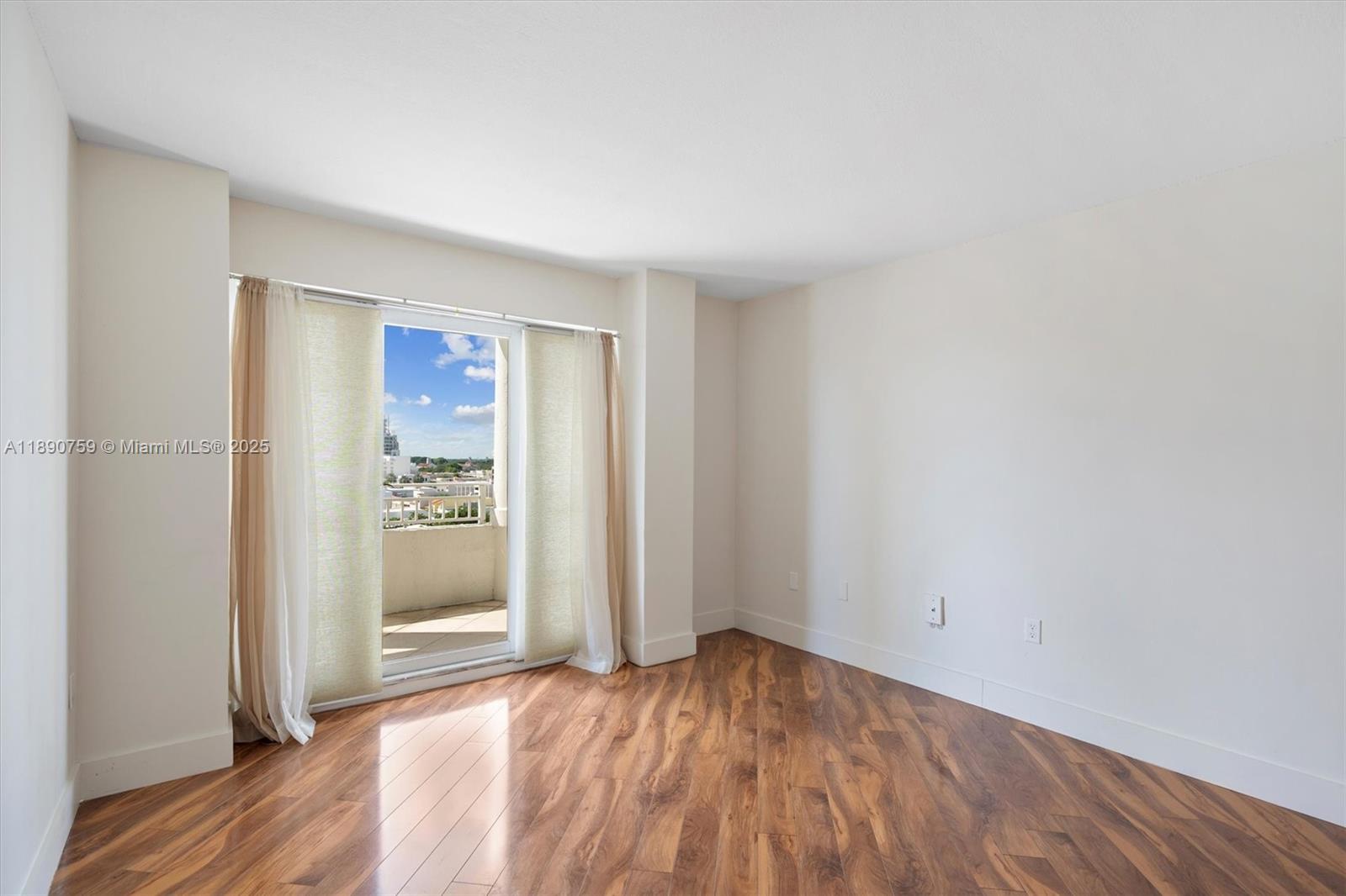2351 Douglas Road, Unit 906 Miami, FL 33145 - Photo 21 of 45 an empty room with wooden floor and windows