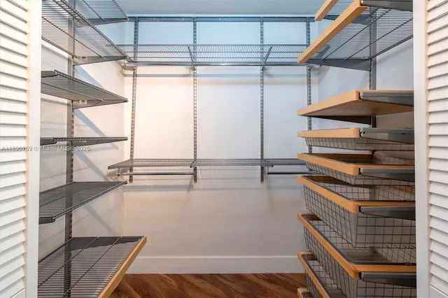 a view of walk in closet with empty racks